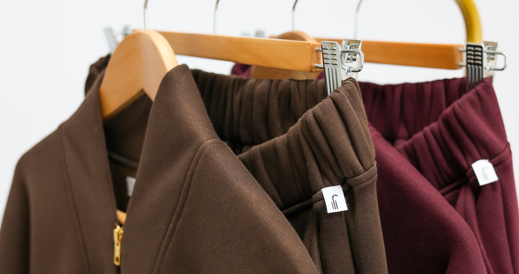 Brown and maroon coats hanging on a rack with visible Wild Geese brand labels.