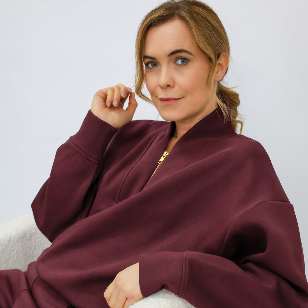 Burgundy sweatshirt with gold zip detail and stand up collar