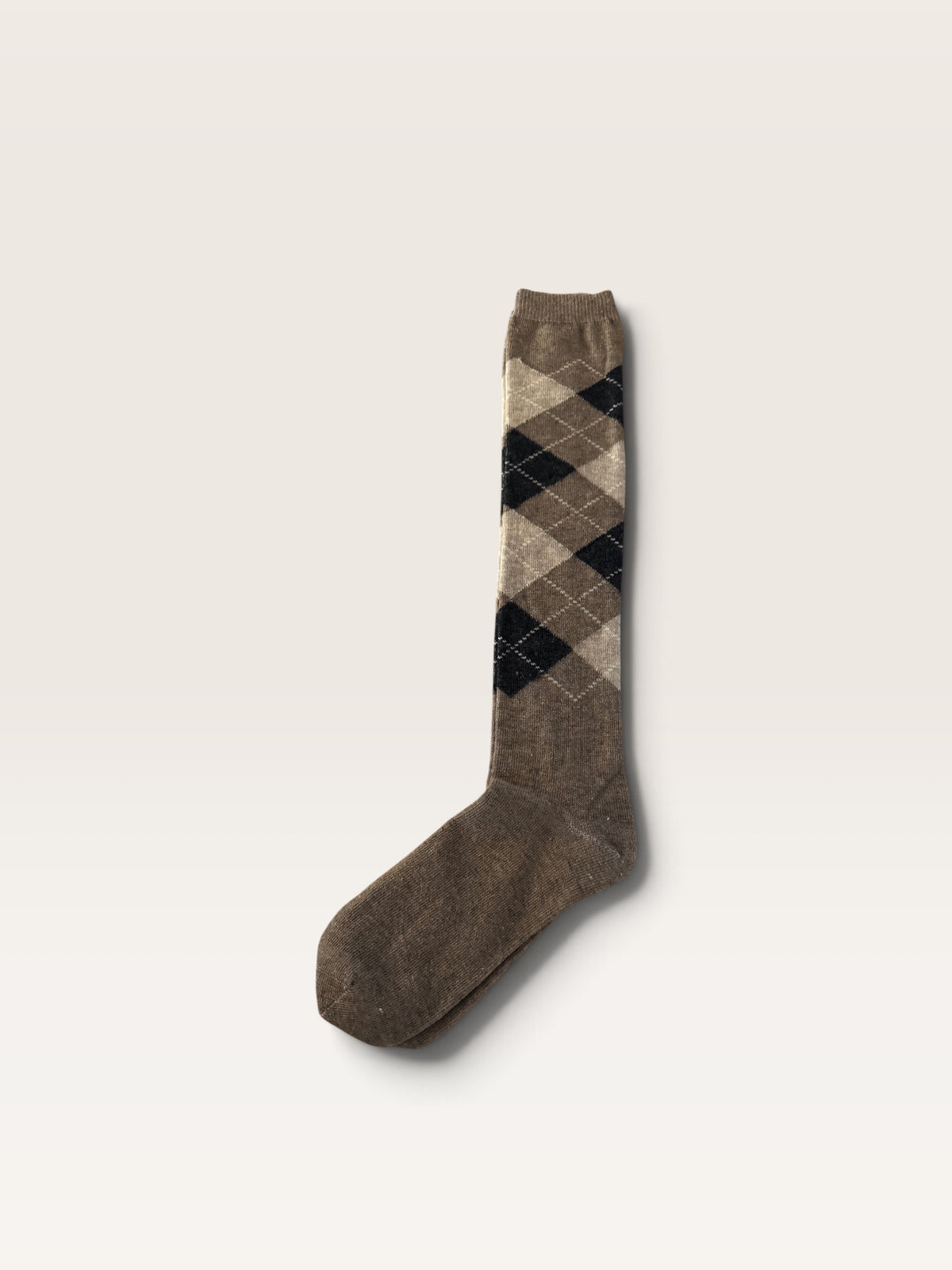 Knee-high argyle alpaca sock with a solid brown toe and heel, featuring an argyle pattern in beige, brown, and black.