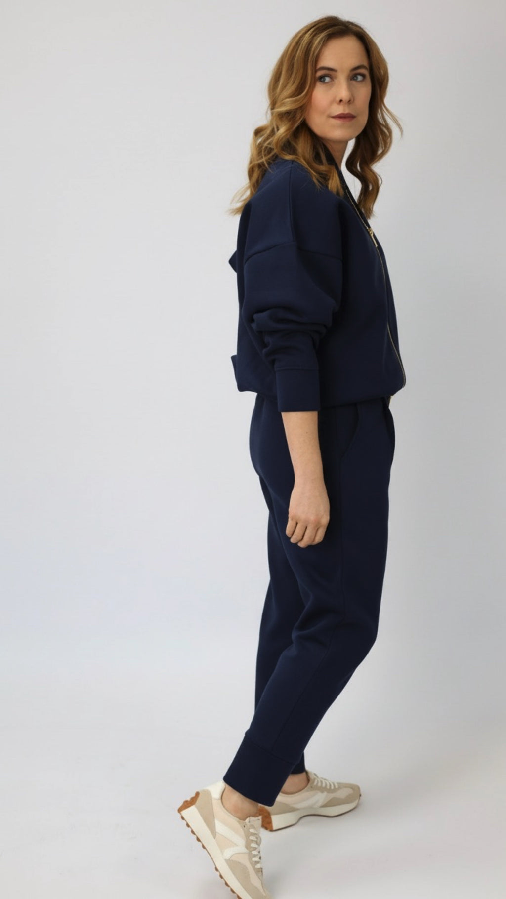 Woman wearing a navy blue sweatpants and sweatshirt