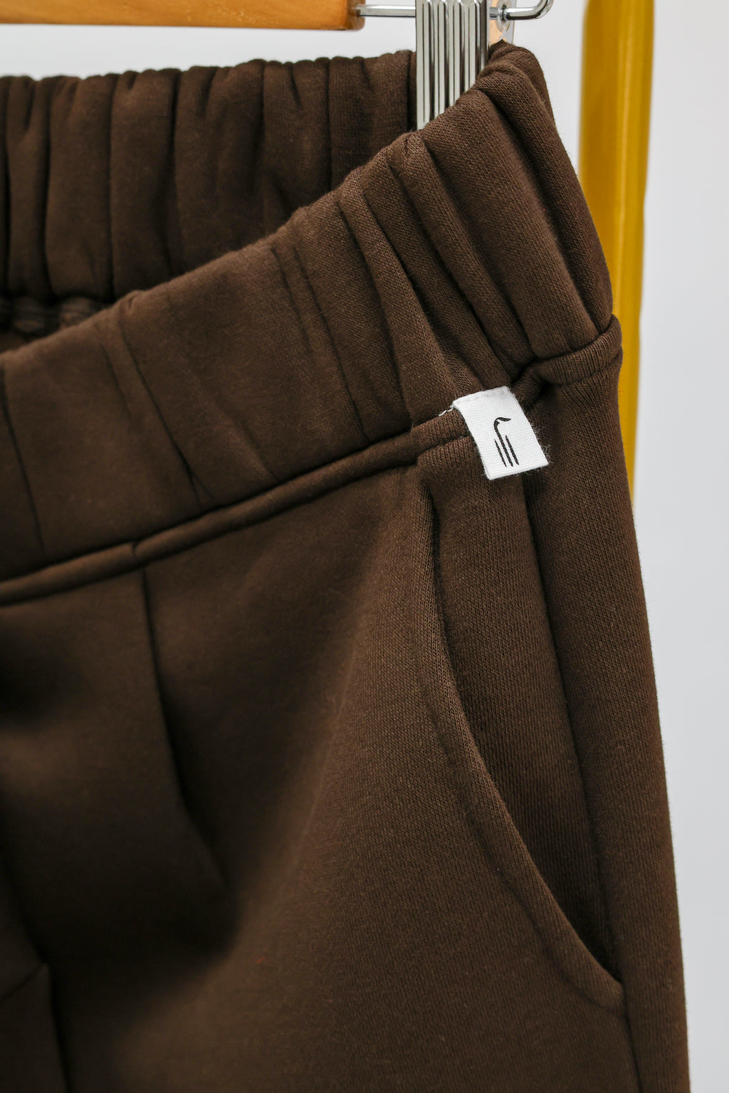 Detail of Wild Geese label on chocolate brown joggers