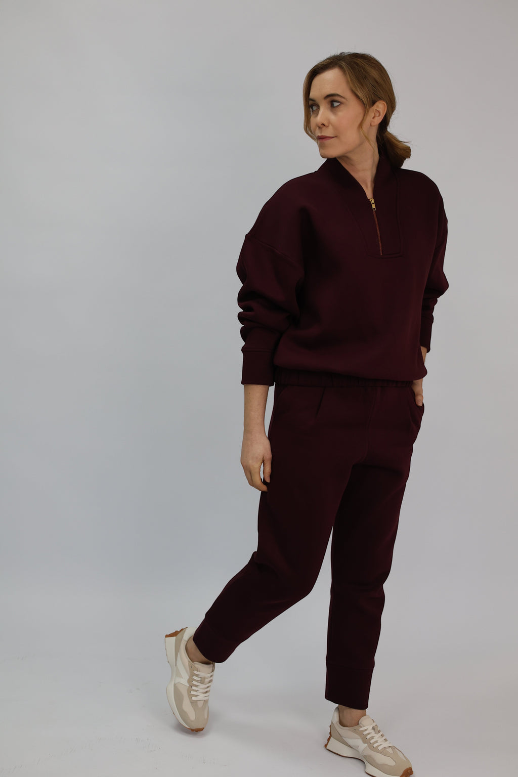 Wild Geese Margot Relaxed Cigarette Sweatpants in burgundy, made from 100% cotton with fleece lining. Features front pleats and a tapered leg.