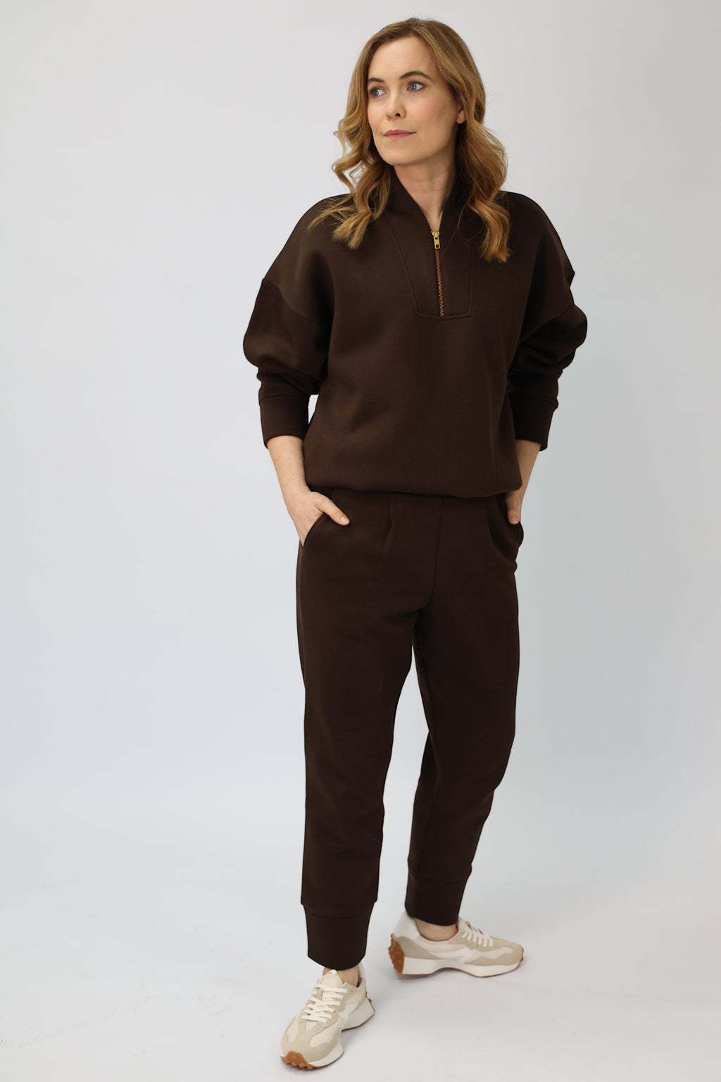 Wild Geese Margot relaxed cigarette sweatpants in chocolate brown cotton with fleece lining. Tapered leg and front pleats.
